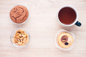Food concept. Cakes and cup of delicious tea for happy day. Top view. Space for a text.