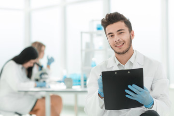 close up. a scientist doing writes the results of an experiment to a laboratory journal