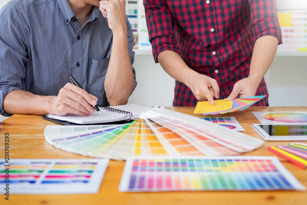 Poster team interior designer drawing a new project using graphic computer and choosing color swatch sample