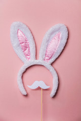Easter bunny ears with white moustache on a pastel pink background