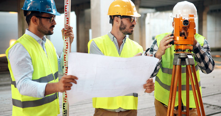Portrait of construction engineers working on building site