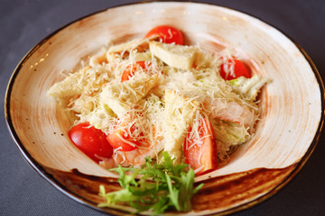 Plate with caesar salad on table, close up