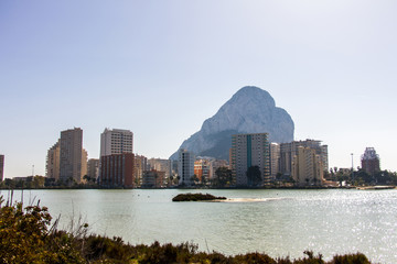 Nature park of Las Salinas lake in Calpe, Spain, with some flamingos. The city and the Penon of...