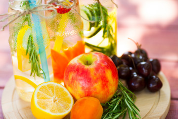 Fresh detox juices in glass bottles on the wooden background. Fruits and berries. Lifestyle, vegan food and drink, health care, diet and summer concept. Top view. Close up.