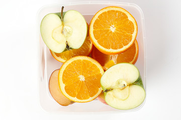 Fototapeta na wymiar mix green red apple orange whole fruit cut slice half in plastic container on white background