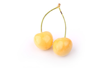 two yellow sweet cherries isolated on white background