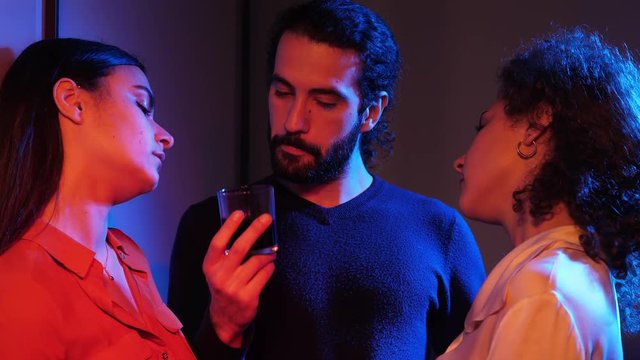 poliamorous Flirt, kisses .three people flirting,kissing in a nightclub