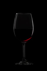 Fototapeta na wymiar Glass of red wine on black background. Concept studio shot.