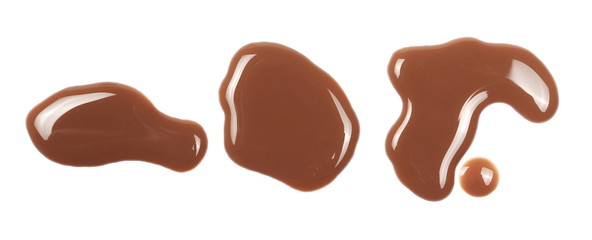 Chocolate milk puddle isolated on white background, top view