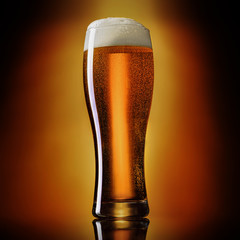 Glass of classic india pale IPA beer on a gradient background..