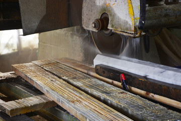 worker cutting metal with saw