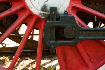 large steel wheels of old steam locomotive red with white outline