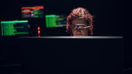 Woman hacker with reflection on her face