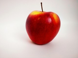 red with yellow apple on white background