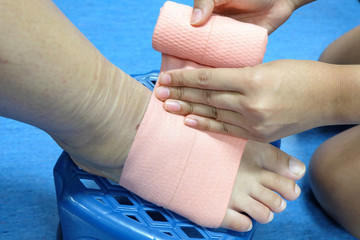 Roll a bandage for protect foot. Wrap foot bandage.