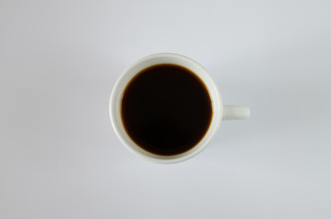White cup of coffee isolated on white background, top view