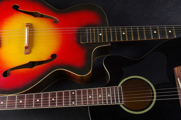 Obraz na płótnie Canvas Two acoustic guitars on dark
