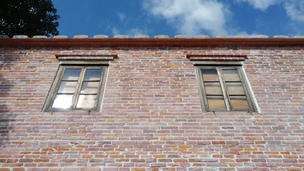 Traditional ancient gothic style window. Old vintage window on stone wall