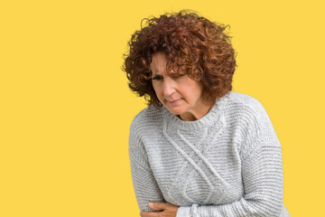 Beautiful middle ager senior woman wearing winter sweater over isolated background with hand on stomach because nausea, painful disease feeling unwell. Ache concept.