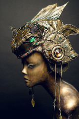 Bronze head of mannequin in decorated bronze fantasy hat