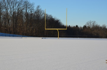 Football field covered in winter snow