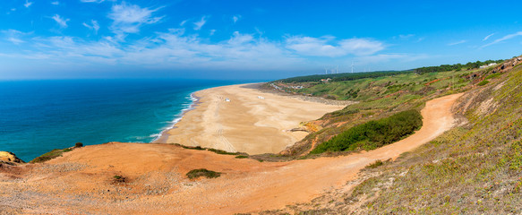 Obraz premium Scenic view of surf beach and ocean near Nazare Portugal