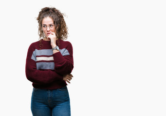 Beautiful brunette curly hair young girl wearing glasses over isolated background looking stressed and nervous with hands on mouth biting nails. Anxiety problem.