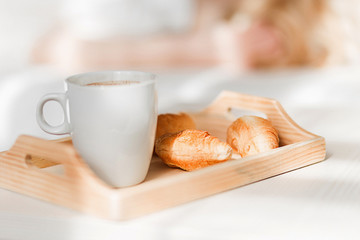 Fototapeta na wymiar Breakfast with cup of black coffee and croissants
