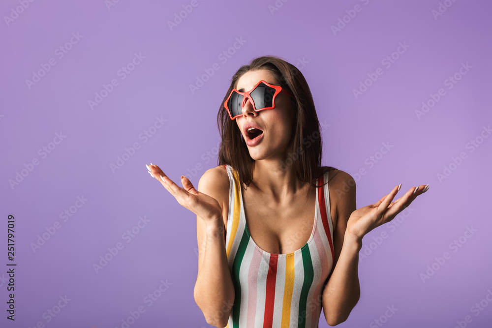 Canvas Prints Cheerful young girl wearing swimsuit standing