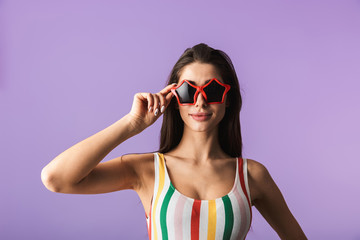 Cheerful young girl wearing swimsuit standing