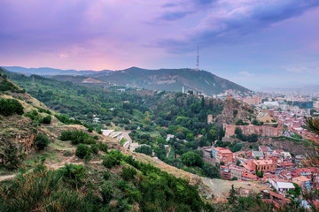 Fototapeta na wymiar Sunset on the hills of Georgia over the city of Tbilisi