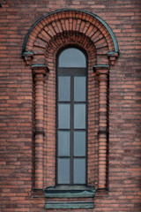 Art Nouveau semicircular window in a red brick wall