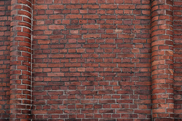 background of a brick red wall with half columns