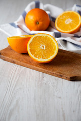 Halved and whole oranges, side view. Close-up. Space for text.