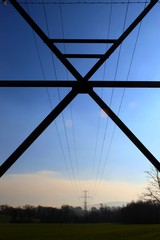 Low Angle View Of Electricity Pylon Against Clear Blue Sky