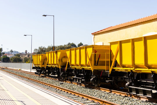 Ballast train. A large cargo yellow train at the station