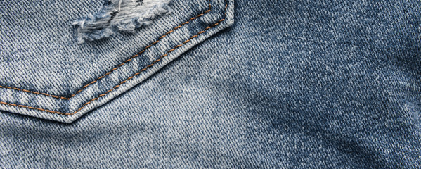 Denim blue jeans texture with scuffs and holes. Abstract background.