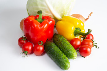 Vegetables Bulgarian pepper tomatoes cabbage cucumbers onions and garlic on a white background
