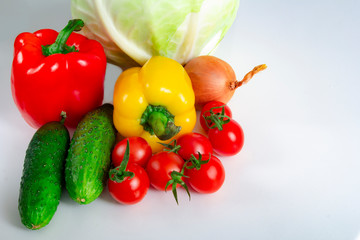 Vegetables Bulgarian pepper tomatoes cabbage cucumbers onions and garlic on a white background