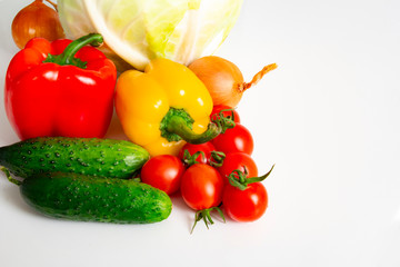 Vegetables Bulgarian pepper tomatoes cabbage cucumbers onions and garlic on a white background
