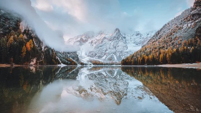 Calm alpine lake Braies. Location Dolomiti, national park Fanes-Sennes-Braies, Italian Alps, Europe. Beauty of earth. Footage before and after. Example of photo editing process. Shooting 4K video.