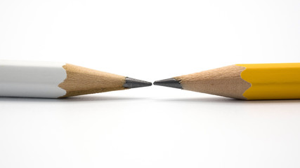 white and yellow pencil tip close up on white background.