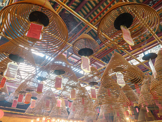 Circular incense coils in the Man Mo temple, Hong Kong Island - 251803054