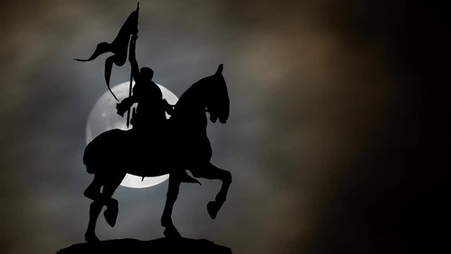 Joan of Arc or Jeanne d'Arc Bronze Equestrian Statue in Paris by Night with Full Moon; is considered a Heroine of France, and Roman Catholic Saint