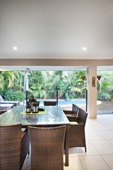 Bamboo stick chairs and glass dining table