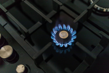 Cost of gas, concept crisis. Gas stove with coins in flame. The cost of methane. Gas coins more...