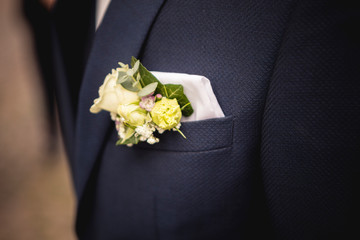 Flower focus shot on groom suit
