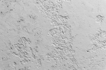 Black and white concrete wall with pieces of plaster dropped off