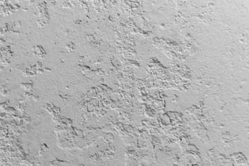 Black and white concrete wall with pieces of plaster dropped off