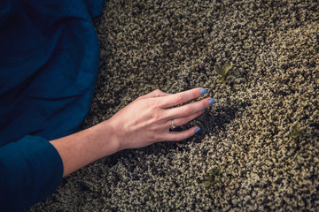 Cinematic view of thoughtfull woman in depression touching the stone moss in nature and exchanging emotion energy